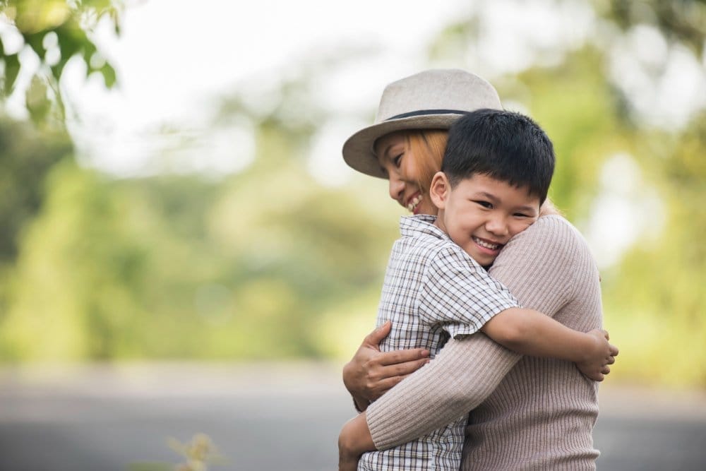 portrait mother son happy cuddle together park family concept